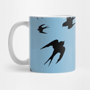 Flying swallows  silhouettes pattern on pale blue background Mug